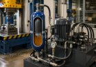 How does a hydraulic accumulator improve system efficiency and performance?