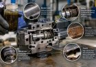 How does hydraulic oil contamination damage valves?